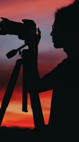 Woman taking a photo in low light or darkness.