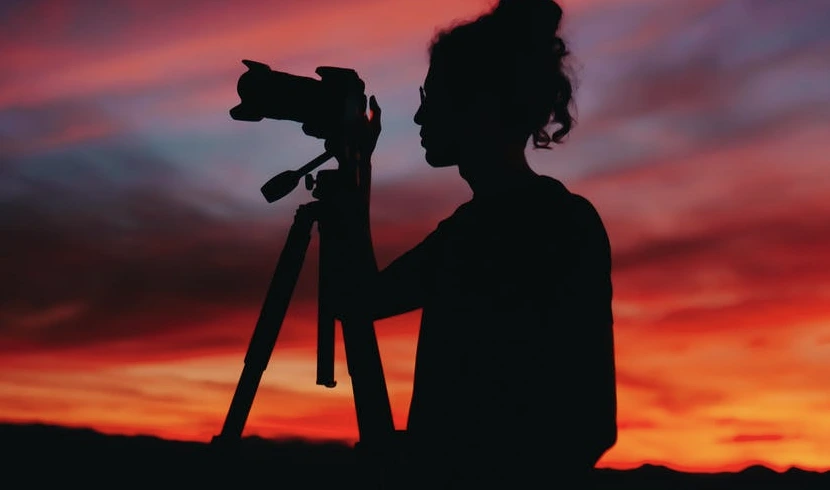 Woman taking a photo in low light or darkness.