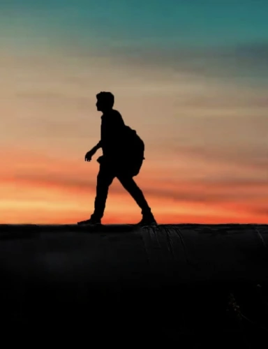 A hiker walking on flat terrain under a starry night sky.