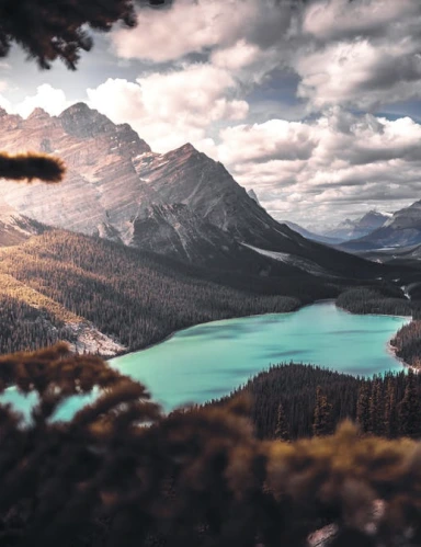 A sunny mountain peak with a moody sky.