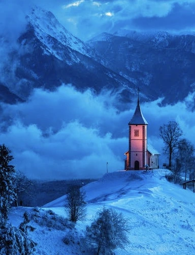 A small town with a church in the foreground and open landscape behind.